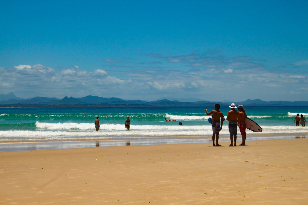 Surfers on the beach in Byron Bay, Australia.